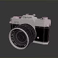 Canon Vintage Camera With Silver Black Body And Lens On Reflective Surface