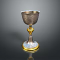 Artisan Crafted Silver Goblet With Intricate Carved Patterns And Golden Base