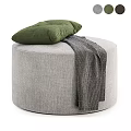 Gray Upholstered Round Ottoman Bench With Yellow Cushion And Gray Knit Blanket