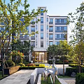 Modern Residential Building With Landscaped Gardens Trees And Contemporary Sculpture
