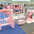 Pink Themed Tea Break Area With Cherry Blossom Backdrop White Bench Cart And Blue Carpet