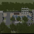 Industrial Plant Facility With Green Trees Surrounding Parking Area And Buildings
