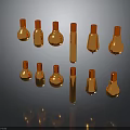 Golden Metallic Bottles in Various Shapes with Reflections on Dark Background