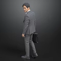 Businessman in Gray Suit Carrying Black Briefcase Standing Sideways on Gray Background