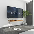 Large Screen TV Mounted On Wall With Wooden Metal Stand Green Plant And Grey Rug