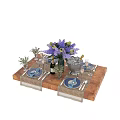 Elegant Tableware Set with Blue Napkins Plates Wine Glasses and Purple Flowers on Wooden Table