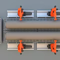 Automated Industrial Equipment With Orange Robotic Arms Handling Large Pipes On Conveyor Belts
