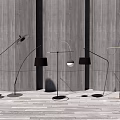 Modern Curved Floor Lamps With Black And Metallic Shades Against Gray Wall And Wooden Floor