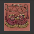 Pair Of Decorative Tassel Ornaments With Embroidered Design On Pink Display Board