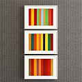 Three Framed Colorful Vertical Stripe Paintings With White Frames On Gray Wall
