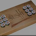 Assorted Sushi Rolls On Wooden Tray With Chopsticks And Engraved Sushi
