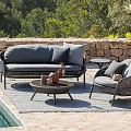 Gray Wicker Outdoor Sofa with Cushions in Poolside Garden and Armchair Coffee Table