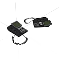 Two Black Landline Telephones With Display Screens Keypads And Coiled Cords