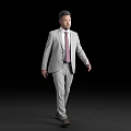 Full length man in gray suit with pink tie walking on black background