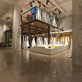 Stylish Bridal Shop Interior With Hanging Wedding Dresses And Display Platform Design