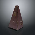 Vintage Pyramid Shaped Dark Brown Metronome With Metal Accents And Knobs As Household Item