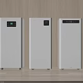 Three White Daily Air Purifiers On Wooden Floor Against Wall With Top Displays Showing Readings