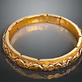 Elegant Golden Bracelet With Intricate Carved Patterns And Shiny Surface