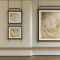 Three Black Framed Gold And Beige Modern Oil Paintings On White Wall With Wooden Floor