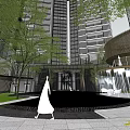 Modern Sales Office Building Featuring Glass Curtain Walls Green Plants And High Rise Residential Background