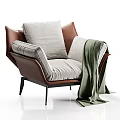 Modern Brown Leather Armchair With Light Gray Fabric Cushions And Green Throw Blanket