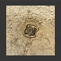 Intricate Sandcastle Structure On Sandy Ground With Detailed Design And Small Openings