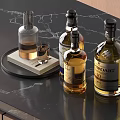 Wine Bottles And Glass On Black Marble Table With BOWMORE And Various Labels
