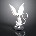 White Sculpture With Large Ears Big Eyes And Curled Tail Sitting On Stone Base