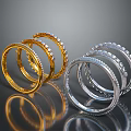 Stacked Gold And Silver Bracelets With Inlaid Decorations On Dark Background With Reflections