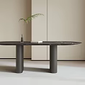 Minimalist Modern Dining Table with Black Tabletop Two Cylindrical Legs Vase Green Plant and Book