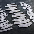 White Stone Stepping Stones Arranged on Black Ground for Garden Pathway Design