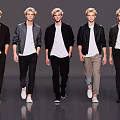 Group of Men Models Showcasing Fashionable Jackets And Pants While Walking
