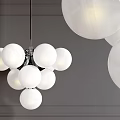 Modern Chandelier With Cluster Of White Globe Lights Hanging Against Gray Wall