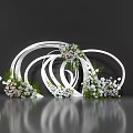 Artistic Floral Installation with Intertwined White Circular Frames White Pink Flowers and Green Foliage