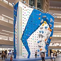 Indoor Rock Climbing Wall With Colorful Holds For Fitness Workout People Climbing In Mall
