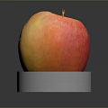 Fresh Ripe Red and Yellow Apple on White Circular Base Against Dark Background