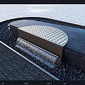 Curved Garden Water Feature With Perforated Top Flowing Water Black Pebbles And Gray Stone Pavement