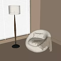 Round White Single Sofa With Pillow And Blanket Near Floor Lamp And Window Blinds