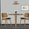 Round Wooden Table and Chairs with Black Seats Vase Flowers Wall Art and Ceiling Lamp