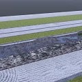Rockery Stones in Front With Green Grass White Sand Wavy Patterns And Blue Water