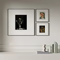 Modern Interior Decor With Three Framed Artworks And Sculptures On Shelf