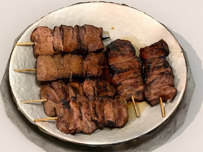 Grilled Meat Skewers on a Textured White Plate with Juicy Charred Pieces 3d model