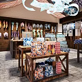 Traditional Fabric Store With Wooden Shelves Hanging Clothes And Stacked Blue White Patterned Fabrics
