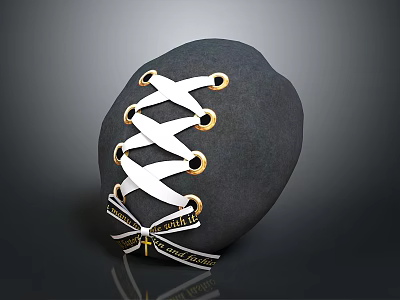 Black Stone Sculpture With White Lacing Golden Rings Crisscross Design And Text Label 3d model