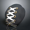 Black Stone Sculpture With White Lacing Golden Rings Crisscross Design And Text Label
