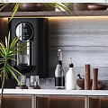 Stylish Decorative Ornament Combination On Countertop With Green Plant Glass Bottles And Wooden Accents