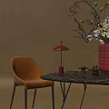Orange Upholstered Dining Chair With Black Marble Table And Red Table Lamp