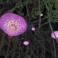 Vibrant Purple Leopard Patterned Jellyfish Hanging Among Tree Branches With Green Leaves At Night