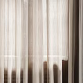 Sheer Lightweight Beige Curtains Filtering Soft Natural Light Through Window Panels