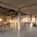 Modern Industrial Restaurant Interior With Tables Chairs Columns Large Windows And Abundant Light